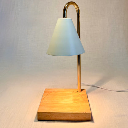 Table lamp with wooden base and white shade on a light gray background