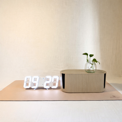 Digital clock, Beige Cable Management box and Beige Desk mat with a neutral background