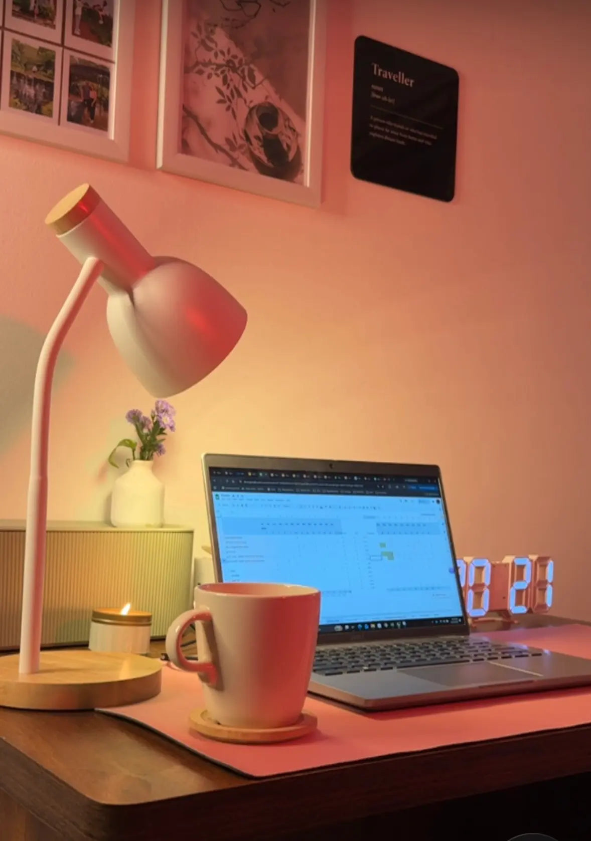 Cozy desk setup -white desk lamp with wooden base, a laptop and  mug.